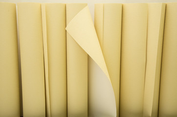 Yellow wallpapers in a row ready for applying on the wall