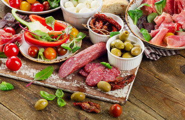 Appetizer set. Meat, vegetables on wooden board.