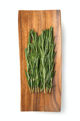 sprigs of rosemary on a wooden plate isolated on white background