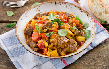 Stew on old wooden table.
