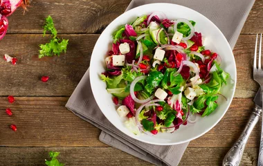 Foto auf Acrylglas Fresh green salad with feta cheese and pomegranate. © bit24