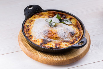 cottage cheese casserole on pan with powdered sugar