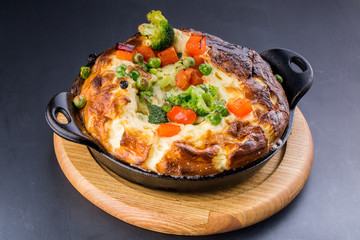 Fresh ham and cheese omelet in fry pan