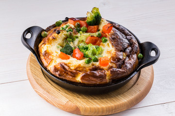 Fresh ham and cheese omelet in fry pan