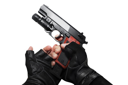 Hands In Leather Gloves Reloading A Gun Clip First Person View Isolated Photo.