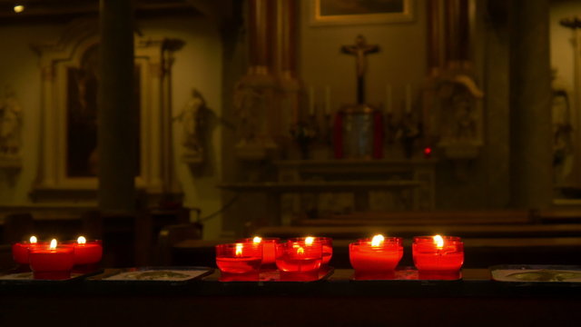 Red candles in a church 4K