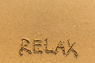 Relax - inscription on sand beach.