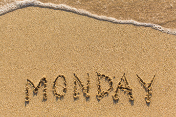 Monday - word drawn on the sand beach with the soft wave.