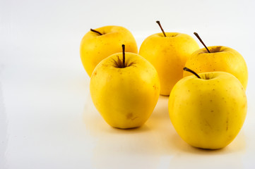 Yellow apples on the white background. Isolated