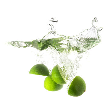 Limes splash on water, isolated on white background.