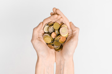 Money and Finance Topic: Money coins and human hand showing gesture on a gray background in studio top view