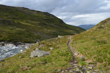 Hiking trail and mountain river in subarctic tundra valley, Swedish Lapland