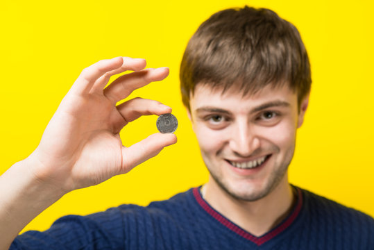 Man Holding A Penny