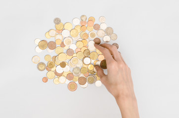 Money and Finance Topic: Money coins and human hand showing gesture on a gray background in studio top view