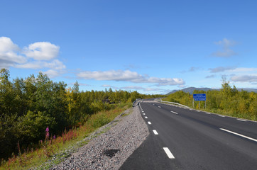 Fototapeta na wymiar Asphalt road from Kiruna to Narvik, subarctic Swedish Lapland
