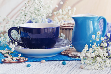 Cup of coffee with milk on a white wooden table