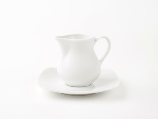 white cream jug with saucer