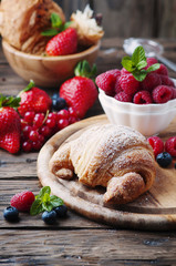 Fresh croissant with mix of berry
