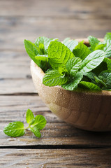 Green fresh mint om the wooden table