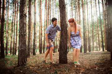 Naklejka na ściany i meble a young couple in love walking in the woods