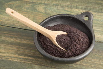 acai powder in wooden spoon