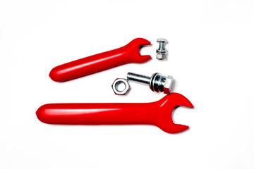 Two Red rubbered tools screw on white surface. Isolated