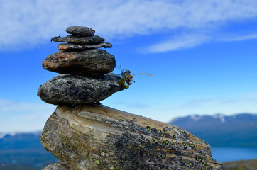 Stone cairn, stone man, trailmark construction on top of a mountain in subarctic Swedish Lapland