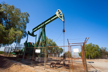 Fototapeta na wymiar Pump jacks extract oil from an oilfield in USA