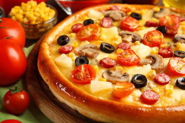 Delicious pizza with vegetables and meat, close-up