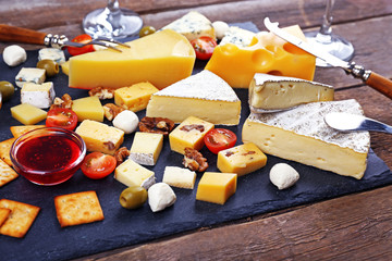 Cheese for tasting on wooden table, closeup