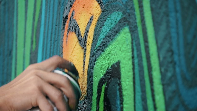 Graffiti artist drawing on the wall