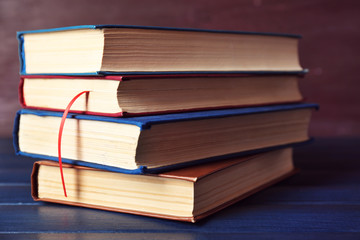 Pile of books on wooden background