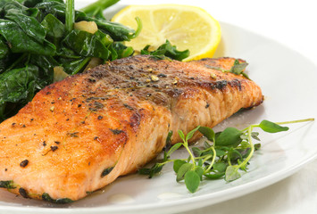 grilled salmon with thyme, lemon and spinach on white, vegetaria