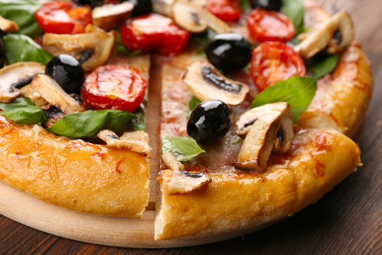 Sliced delicious tasty pizza, closeup