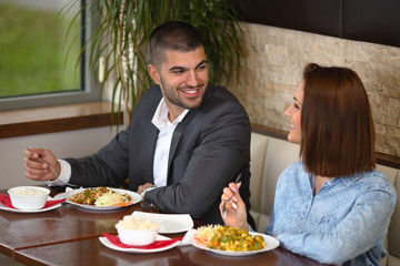 Happy young couple having a romantic lunch in a restaurant