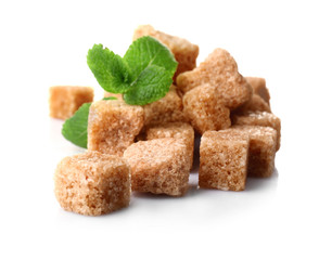Pile of brown sugar cubes and stevia isolated on white background