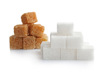 Pile of brown and white sugar cubes isolated on white background