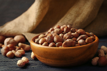 Hazelnuts in the bowl on the table, close-up
