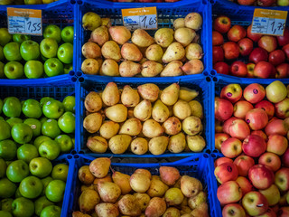 Pears and apples on sale in baskets