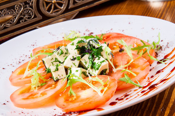 Salad with tomatoes, cheese, herbs