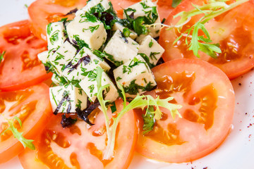 Salad with tomatoes, cheese, herbs