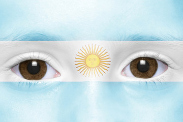 human's face with argentinean flag