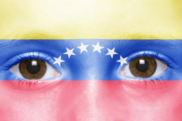 human's face with venezuelan flag