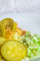 Mashed potatoes, gravy polytoe meat slices of fried meat. Salad of Chinese cabbage. Delicious lunch restaurant food. Dude looks sochno and delicious