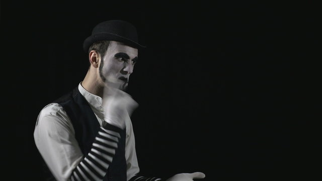 Young funny mime quarreling with somebody