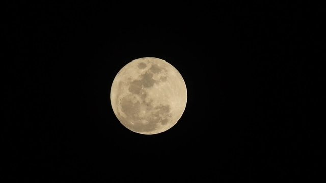 clear moonface of the full moon on black sky