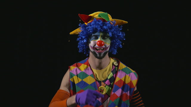 Young funny clown sneezing