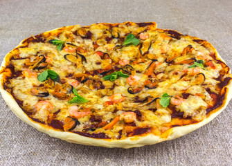 homemade pizza with seafood on linen tablecloths  adorned with m