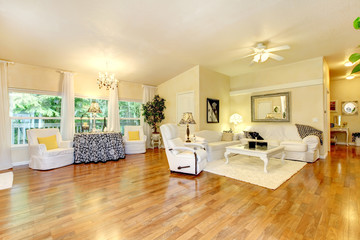 Amazing living room with white furniture and hard wood floor.