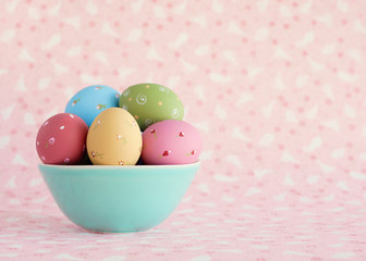 Vintage pastel easter eggs over flower patterned background